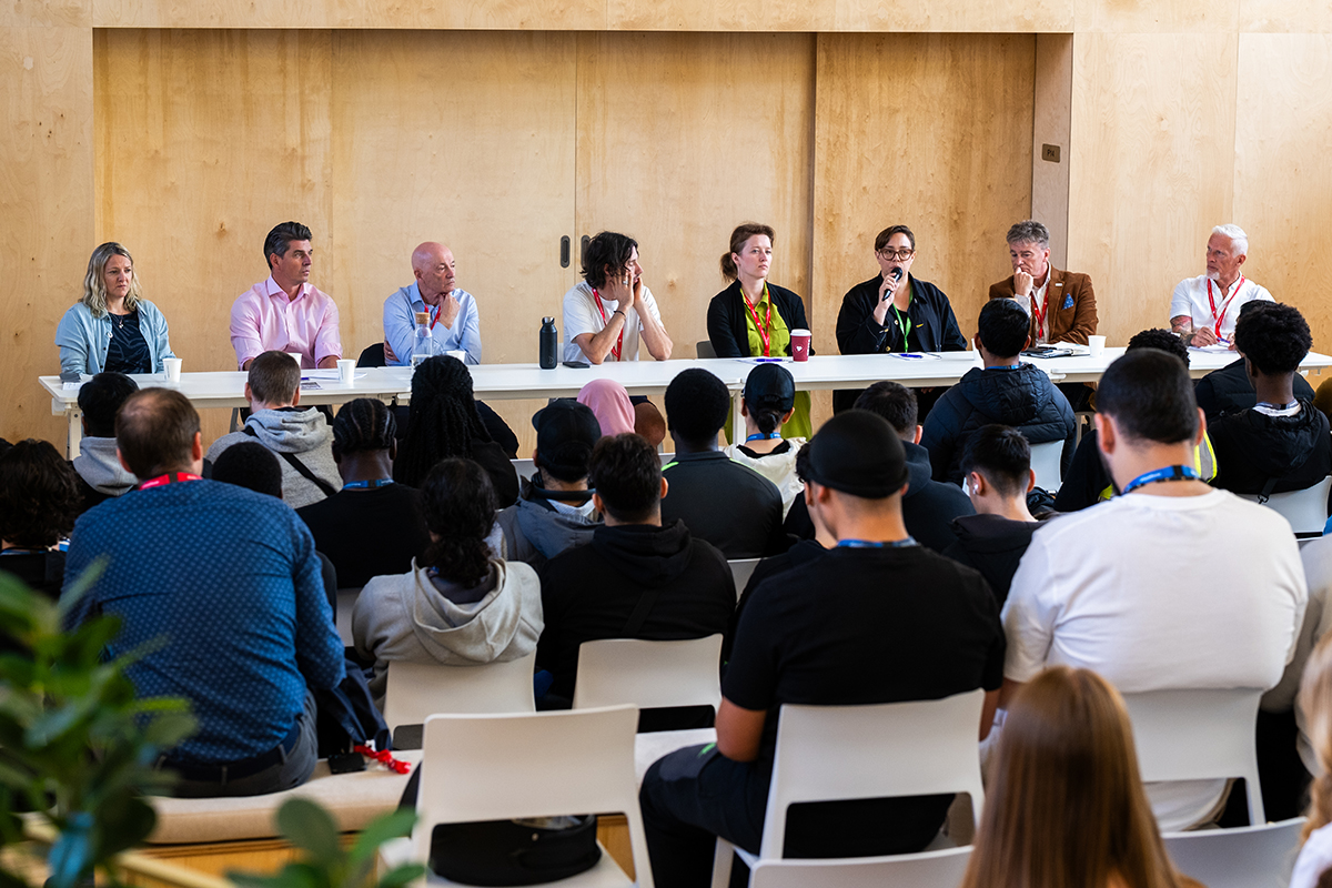 Panelists of Build Tomorrow sit in front of audience in the College's sustainable retrofit space