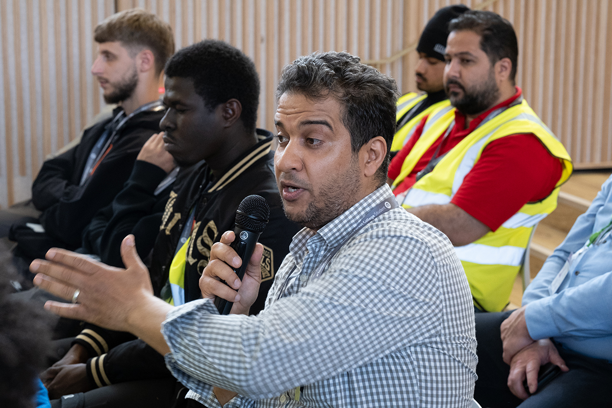 student speaks to panel using microphone