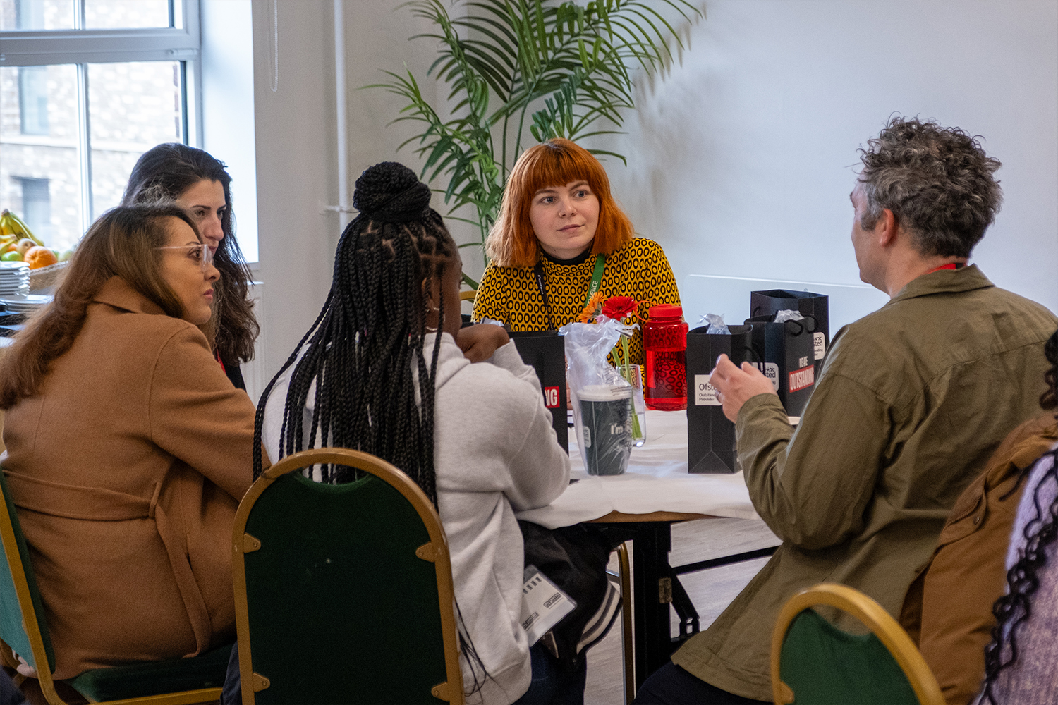 Staff and employers talk around a table