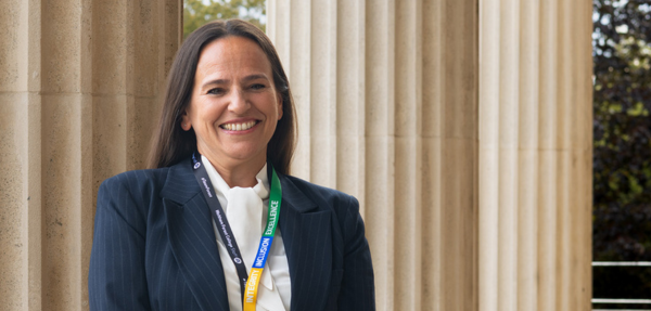 Principal Jane Button stands in front of pillars