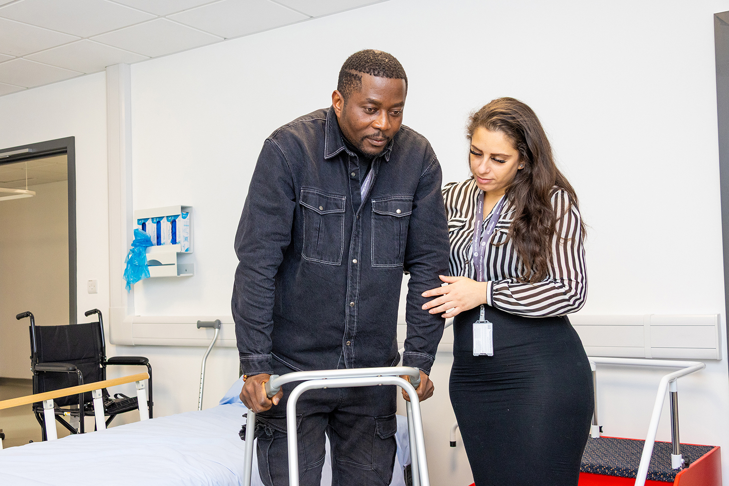 female student takes blood pressure reading from another student