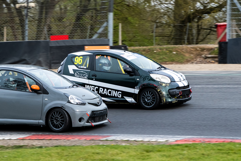 Waltham Forest College's race car overtaking another car around a corner