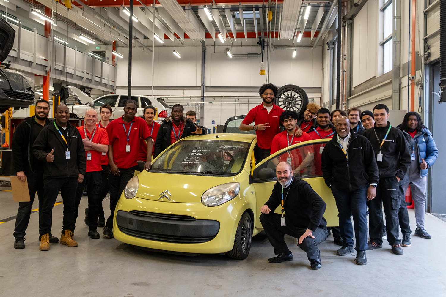 students and staff surround Citroen C1 car