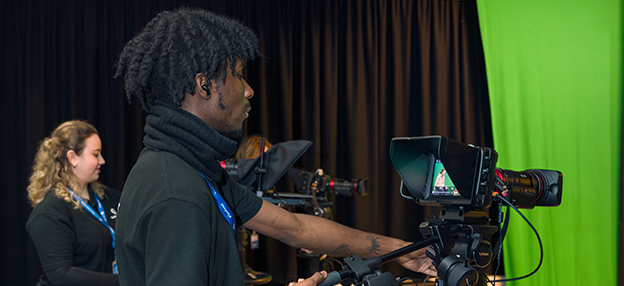 T Level student using camera in media production suite